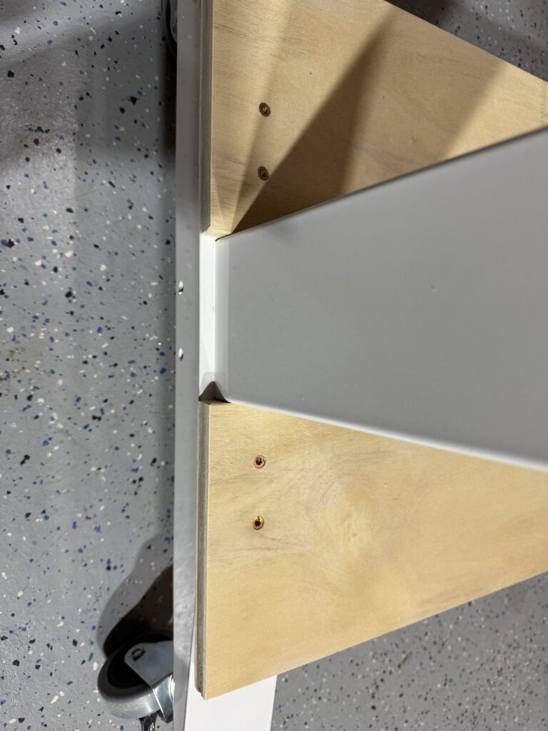 Close up of the how I attached the cabinet bottom to the Husky adjustable-height table.